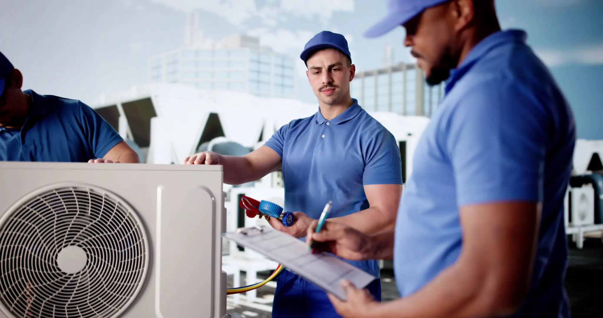 Two technicians inspecting an air conditioning unit outdoors.